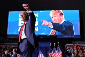 Now two-time U.S. President Donald Trump gestures to the crowd at the conclusion of his final campaign rally on Election Day at Van Andel Arena in Grand Rapids.