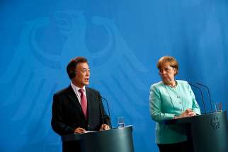 South Korean President Moon Jae-in is seen with German Chancellor Angela Merkel in Berlin July 5. The Catholic Bishops&#039; Conference of Korea welcomed Moon&#039;s peace initiative with North Korea, saying it matches the church&#039;s views on how peace can be achieved in the region.