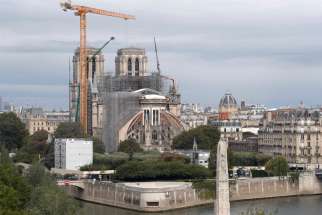 Workers remove scaffolding from the remains of the roof of the damaged Notre Dame Cathedral in Paris July 14, 2020, after the historic cathedral was partially destroyed in a 2019 fire. A new study has found that the amount of lead that settled to the ground and likely seeped into houses downwind of the fire was far greater than officials indicated at the time.