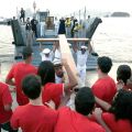 Young Catholics receive the World Youth Day Cross from sailors of the Brazilian Navy during its arrival at Icarai Beach in Niteroi, Brazil.