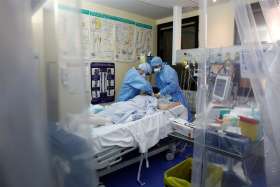 Medical staff, wearing protective suits and face masks, treat a patient suffering from COVID-19 in an intensive care unit of a hospital near Paris April 15, 2020. Pope Francis created a new commission that will confront the challenges the world is facing in battling the coronavirus pandemic and what it will inevitably face in its aftermath, the Vatican announced in a statement published April 15.