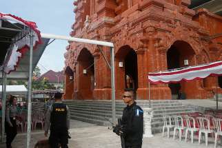  Indonesian police bomb squad members check a cathedral prior to the Christmas Eve Mass in 2016 in Bali. This year nearly 50,000 churches across Indonesia, including some previously attacked by terrorists, are to be guarded during the Christmas period.
