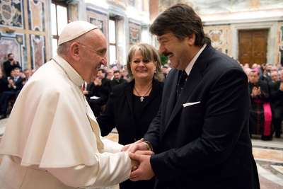 Pope Francis meets a member of a Canadian family led by Vilma Cortelucci-Fiuza, center, at the International Forum on Migration and Peace at the Vatican Feb. 21, 2017.