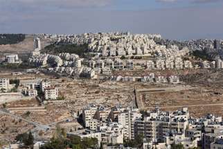 The Israeli settlement Har Homa is seen on the hillside overlooking houses in Bethlehem in the valley in the West Bank, in this Dec. 3, 2019, photo. Israeli Prime Minister Benjamin Netanyahu says he will annex Jewish settlements in the West Bank.