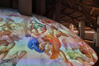 A high resolution image of a scene inside St. Peter&#039;s Basilica is projected on top of the basilica&#039;s cement cupola during an immersive exhibit at the Vatican Nov. 11, 2024. The exhibit was created with the support of Microsoft and Iconem.