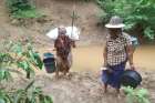 Villagers displaced by fighting in eastern Myanmar cross a river in Kayah state June 12, 2021. Myanmar&#039;s military has arrested seven workers from the Catholic Church&#039;s social arm Caritas (Karuna) who were on a mission to provide aid for internally displaced persons in Kayah.