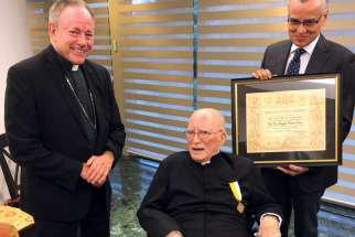 Fr. Joseph Soria, centre, receiving the papal award Cross Pro Ecclesia et Pontifice from Vancouver Archbishop J. Michael Miller in 2020.