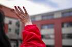 Kim Karrys waves to her mother and a friend in Providence Healthcare. There has been an outbreak with 11 positive cases of COVID-19 in the long-term care section of the hospital.