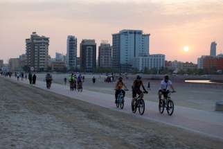 People ride their bikes during sunset in Manama, Bahrain, July 14, 2020. The Vatican has confirmed Pope Francis will visit Bahrain Nov. 3-6, 2022.