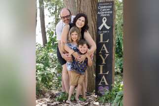 The Marchands, Joe, Dawn and six-year-old twins Juno, left, and Hayden, at Layla’s cancer awareness marker. Joe donated a kidney to a four-year-old boy in honour of his stepdaughter Layla who died at age 12 from a rare form of cancer.