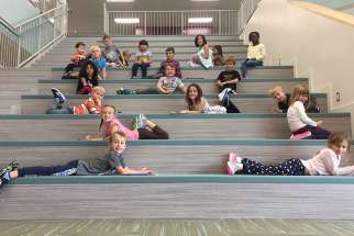 Grade one students relaxing on Ecole St. Elizabeth’s presentation stairs.  Some 11,000 children moved into new P3 schools this fall in Saskatchewan.  