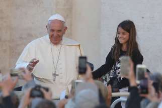 A girl prepares to meet Pope Francis during his general audience in St. Peter&#039;s Square at the Vatican Oct. 5.