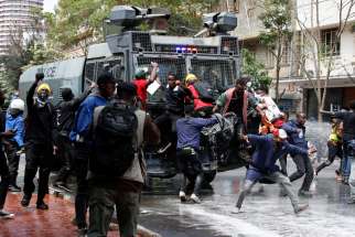 Demonstrators try to obstruct a police vehicle as police use water cannons to disperse protesters during a demonstration in Nairobi June 25, 2024, against Kenya&#039;s proposed finance bill to raise taxes. After Parliament passed the measure, it was sent to Kenyan President William Ruto for his signature or other action. In the face of chaos, Ruto rejected the bill June 26.