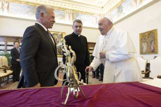 Pope Francis and King Abdullah II of Jordan converse behind a table displaying the king&#039;s gift, a sculpture made of Arabic letters, in the library of the Apostolic Palace at the Vatican May 2, 2024.