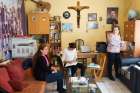 Basima Kamil, right, a refugee from Iraq who teaches at the Don Bosco Youth Center in Istanbul, spends time during a break Oct. 3 at the school office and teacher&#039;s room with colleagues, Wafa Toma and Dina Jouna. Kamil has been in Turkey since December 2012, waiting for an answer to her relocation application to Canada.