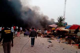 Smoke rises after a bomb blast at the market district in Jos, Nigeria, May 20. Boko Haram has begun occupying churches in Nigeria’s northeastern region.
