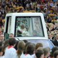 Pope Benedict XVI waves to the crowd as he arrives in his popemobile to celebrate Mass at Berlin&#039;s Olympic Stadium Sept. 22.