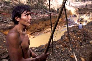 A Yanomami Indian stands near an illegal gold mine during a Brazilian government operation against illegal gold mining on Indigenous land in the heart of the Amazon rainforest.