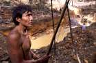 A Yanomami Indian stands near an illegal gold mine during a Brazilian government operation against illegal gold mining on Indigenous land in the heart of the Amazon rainforest.