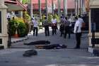  The bodies of two attackers who were shot and killed May 16 are seen at the entrance of a police station in Pekanbaru, Indonesia.