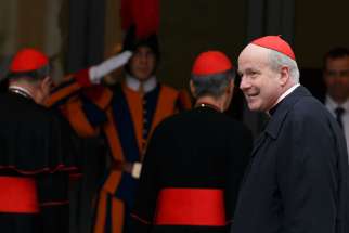 Cardinal Christoph Schonborn of Vienna, right, arrives for the afternoon session of the general congregation meeting in the synod hall at the Vatican March 8. 