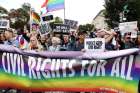 Activists and supporters block the street outside the U.S. Supreme Court in Washington Oct. 8, 2019, as it hears arguments in three major employment discrimination cases on whether federal civil rights law prohibiting workplace discrimination on the &quot;basis of sex&quot; covers gay and transgender employees.