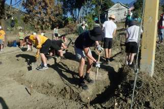 A group of St. Mary’s Catholic Secondary School students dig the foundation for a house during this year’s DREAMS’ service trip in the San José de Ocoa mountains, Dominican Republic.