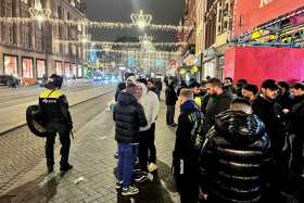 Israeli Maccabi Tel Aviv supporters are guarded by police after violence targeting Israeli soccer fans broke out in Amsterdam Nov. 8.