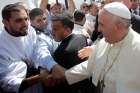 Pope Francis is greeted by pilgrims after arriving to celebrate Mass at Amman International Stadium in Jordan May 24. Celebrating Mass on his first day in the Holy Land, Pope Francis said hope for peace in a region torn by sectarian conflicts comes from faith in God.