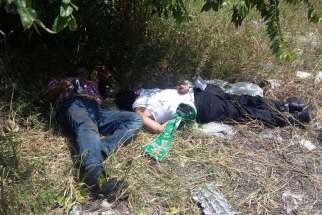  The bodies of Fathers Alejo Nabor Jimenez Juarez and Jose Alfredo Juarez de la Cruz are seen along a roadside Sept. 19 in the Mexican state of Veracruz. The priests were found murdered that day, just hours after they were kidnapped from the low-income neighborhood where they served.