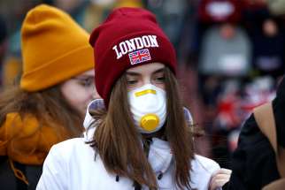 A girl wearing a coronavirus-related protective face mask is pictured in London March 2, 2020.