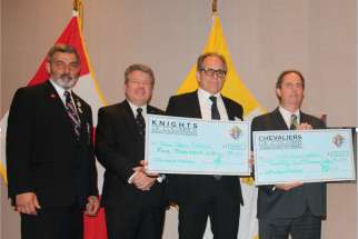 From left to right: State Treasurer Joe Bodnar, State Deputy Bruce Poulin, Dominic Rutigliano from Council 4973 in Brampton displaying a $5K donation and John McNamara from Council 2671 displaying a $25K donation to the Ontario Knights of Columbus Ultrasound Program.