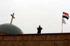 An Iraqi soldier stands guard during Christmas celebrations at the al-Tahira al-Kubra church in al-Hamdaniya, east of Mosul, Dec. 25, 2016.