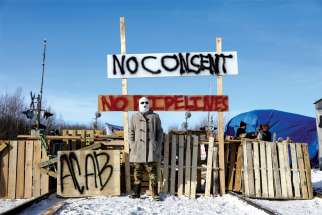 A supporter of the Wet’suwet’en Nation’s hereditary chiefs poses in Edmonton Feb. 19 at a railway blockade as part of protests against British Columbia’s Coastal GasLink pipeline.
