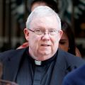 Msgr. William Lynn walks to the courthouse as the jury deliberated during a sexual abuse trial in Philadelphia June 20. He was found guilty on one charge of child endangerment.