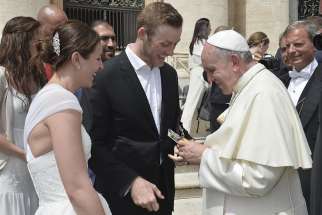 Megan and Ben Turland present Pope Francis with a bottle of maple syrup after the Pope gave the couple’s wedding a papal blessing.