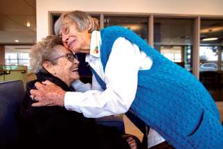 Sr. Marie Donovan is given a welcoming hug by fellow Our Lady’s Missionary Sr. Gwen Legault as she settles into a new life in Presentation Manor. 