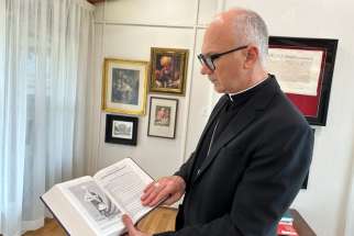 Bishop Joseph reflecting with the Holy Bible given to him by Mr. Harvey Satewas Gabriel