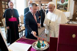 Pope Francis exchanges gifts with Jordan&#039;s King Abdullah II during a private meeting Dec. 19 at the Vatican. At left is Archbishop Georg Ganswein, prefect of the papal household.