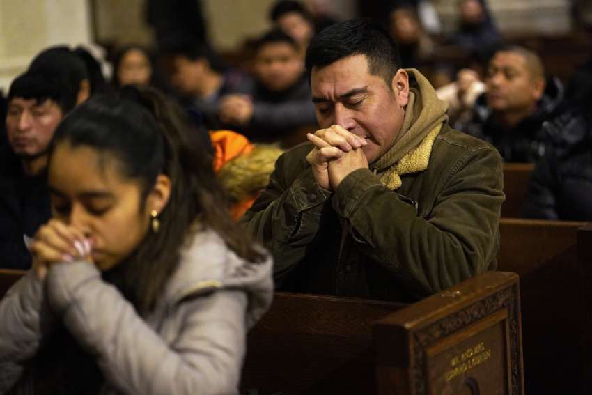 People pray at St. Patrick&#039;s Cathedral in New York City.