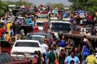 Venezuelans line up to cross into Colombia at the border Feb. 16 in Paraguachon, Colombia. 