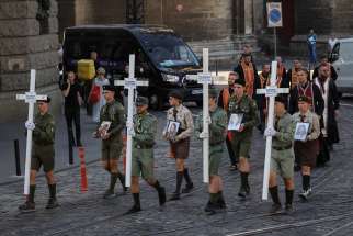 People participate in a funeral ceremony in Lviv, Ukraine, Sept. 6, 2024, for Evgenia Bazylevych and her three daughters, killed during the Russian missile attack on Sept. 4. Yaroslav, her husband, was the only family member who survived the attack.