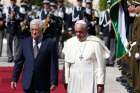 Pope Francis reviews the honour guard with Palestinian President Mahmoud Abbas during an arrival ceremony at the presidential palace in Bethlehem, West Bank, May 25, 2014.
