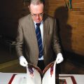 Fr. Gordon Rixon leafs through the pages of the St. John’s Bible at Toronto’s Regis College. 