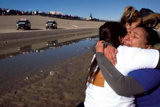Family members embrace in El Paso, Texas, during a massive reunion called “Abrazos, No Muros” (Hugs, Not Walls) Jan. 28. Approximately 375 families separated by immigration issues were allowed to meet for several minutes along the U.S.-Mexico border. Refugee advocates say Canada can expect an influx of refugees due to U.S. policies