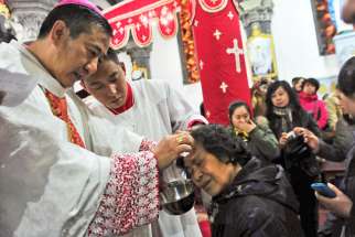 Chinese Catholic priests baptize new believers during a 2013 Easter Vigil in a church in Shenyang, China. The Vatican put out a statement, amidst rumours of new bishops secretly ordinated in China, that ordination of bishops without the papal mandate is a serioius violation of church law. 