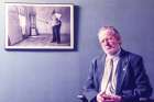 Fr. Peter Larisey, sitting next to a photo of French artist Henri Matisse. Fr. Larisey carved out a career as a Jesuit art historian.