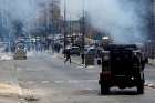 Palestinian protesters run for cover from tear gas fired by Israeli troops during clashes in the West Bank city of Bethlehem.