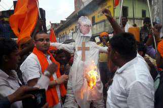 Hindu nationalists are pictured in a recent photo burning an effigy of Cardinal Telesphore Toppo, archbishop of Ranchi, India, Sept. 2017.