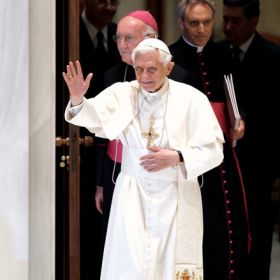 Pope Benedict XVI waves as he arrives to lead his weekly audience in Paul VI hall at the Vatican June 20.